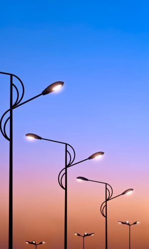 silhouette-row-of-modern-street-lampposts-against-2022-01-15-18-45-09-utc